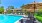 a pool with a patio and umbrella